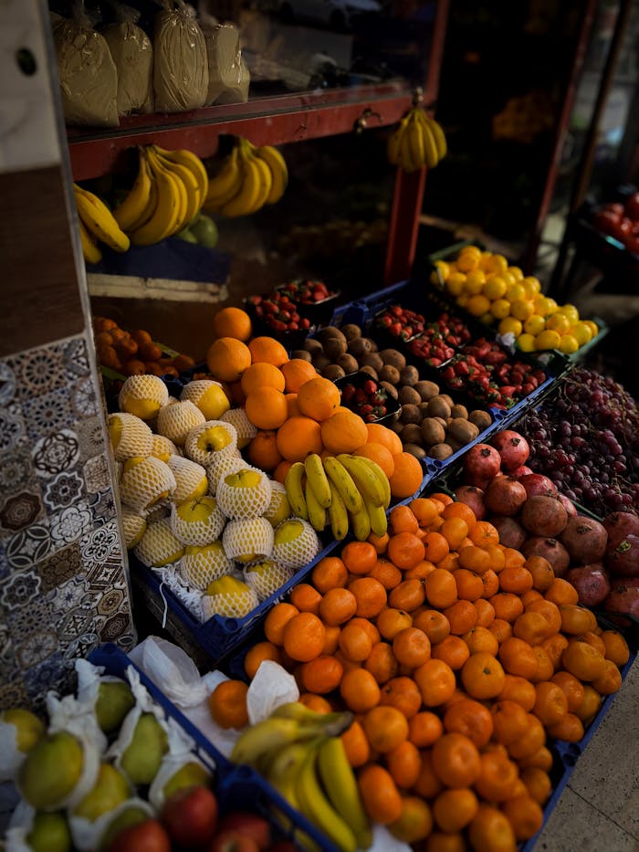 Colorful assortment of fresh fruits at a market stall, ideal for food and travel photography.